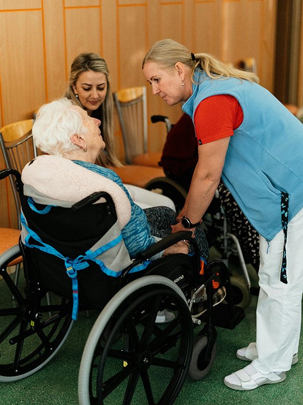 Caregiver with elderly woman in wheelchair