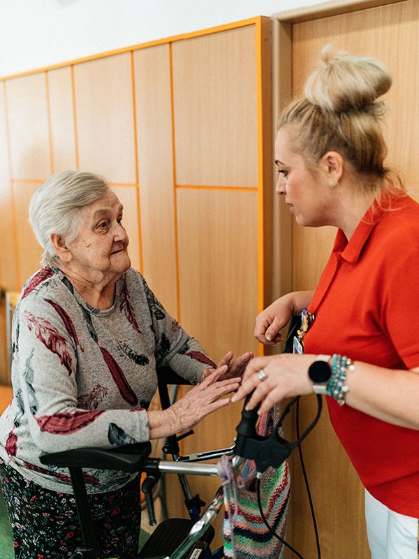 Caregiver talking to elderly woman